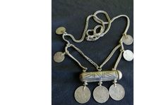 This antique amulet necklace is a work of excellent craftsmanship from the Ottoman period. Silver niello work and elegant silk chain make this necklace a unique and valuable addition to any collection. It is an original antique necklace from the 1800s, bearing his signature on Ottoman coins, contributing to its historical and cultural importance. It weighs 44 grams. Thank you for viewing my ad. All purchases you make from TURKEY are carefully packaged and shipped with tracking. If you need more Ceremonial Coin Pendant Necklace For Festivals, Traditional Handmade Coin Pendant Necklace, Traditional Handmade Pendant Coin Necklace, Coin Pendant Medallion Necklace For Rituals, Traditional Coin Medallion Necklace As A Gift, Traditional Coin Medallion Necklace For Gift, Amulet Style Coin Pendant Necklace, Traditional Necklace With Coin Pendant, Medallion Necklace With Coin Pendant For Rituals