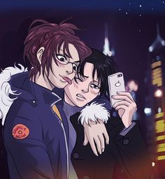 two people standing next to each other in front of a city at night, one holding a cell phone