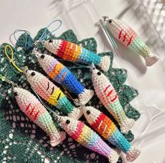 small crocheted fish ornaments are on a doily with scissors in the background