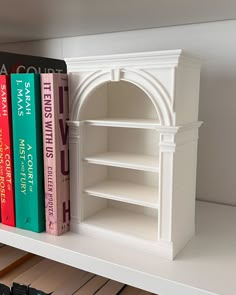 the books are lined up on the shelf next to each other in front of the bookshelf