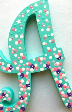 the letters are made out of plastic and decorated with colorful confetti, stars and dots