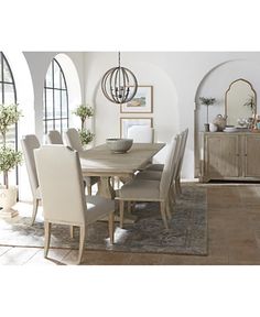 a dining room table with chairs and a mirror on the wall next to an arched doorway