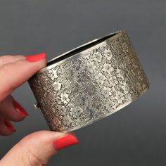 "A stunning silver cuff with floral engraving dating to the Edwardian era (1901-1915). This piece is a mix of the classic and the unusual - classic in its use of floral emblems; and unusual for its extra wide design. It is also in exceptionally good condition for its age, with only minor wear - something seldom found in pieces of this kind. Fully stamped for sterling silver, Birmingham, 1901, maker's mark 'B.H.J.' (B.H. Joseph & Co.). Measurements (approximate): 36mm (1.4\") wide. Internal diameter is 58mm (2.3\") x 48mm (1.9\"). Fits a small to medium wrist. Weight (approximate): 40.1g Condition: Very good, with minor wear commensurate with age. One of the best examples of its kind that I have seen, with minimal dents and scratches. Engraving and stamps are all crisp. Closure functions we Luxury Silver Etched Bangle, Antique Cuff Bracelet With Intricate Design For Formal Occasions, Elegant Stamped Cuff Bracelet, Elegant Etched Bangle For Wedding, Elegant Engraved Ceremonial Cuff Bracelet, Elegant Ceremonial Engraved Cuff Bracelet, Elegant Engraved Cuff Bracelet For Ceremonial Occasions, Silver Etched Cuff Bracelet For Wedding, Elegant Stamped Cuff Bracelet For Wedding