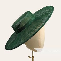 Boaters are all the rage, and this bottle green sinamay fascinator version has us all in a twirl!  Made from 2 layers of stiffened sinamay, these boaters are ready to trim and have a petersham ribbon on it's inside edge. Simply add a comb or headband to secure to the head. Hat base measures: Width: 36.5cm (14.4 inches) Crown Width: Please note that the crown is on the larger side, measures 16.5cm (6.5 inches) wide.  Crown Height: 4.5cm (1.7 inches) For even more millinery supplies you can find us here: www.etsy.com/shop/Petershams All orders are posted daily from London, England with expected delivery times of: Within the UK: 1-5 working days (by 1st Class Post) Outside the UK: 5-15 working days (by Standard Airmail) Upgraded traceable priority services are available for an extra cost, jus Green Evening Fascinator Hat, Green Wide Brim Fascinator For Wedding, Green Top Hat For Summer Church Events, Green Mini Hat With Short Brim For Evening, Green Mini Hat With Curved Brim For Evening, Green Short Brim Fascinator For Evening, Green Fitted Top Hat For Church, Green Brimmed Party Fascinator, Green Top Hat For Kentucky Derby Party