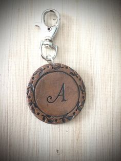 a wooden keychain with an initial on it