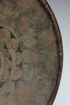 an old wooden bowl with intricate designs on it