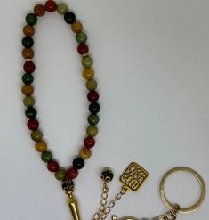 "This stunning Multicolor beaded sibha (prayer beads) features a beautiful and unique design. The beads are carefully crafted with a variety of colors, creating a beautiful and eye-catching pattern. The \"Subhan Allah\" pendant and key chain add a touch of elegance and sophistication to the Sibha, making it perfect for anyone who wants to add a touch of style to their prayer routine. Get your Multicolor beaded sibha now and add a touch of beauty and style to your prayer routine! The Sibha contains 33 beads." Hand-strung Multicolor Beads For Gifts, Bohemian Multicolor 8mm Beads, Multicolor Polished Beaded Bracelets For Meditation, Multicolor Polished Beads Bracelet For Meditation, Multicolor Agate Beaded Bracelets With Round Beads, Multicolor Agate Beaded Bracelets, Spiritual Multicolor Beaded Bracelets, Traditional Multicolor 8mm Beads Jewelry, Multicolor Handmade Jewelry For Blessing