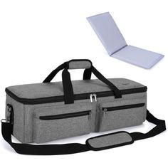 a large gray bag with black straps and an open laptop on the side, next to it