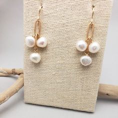 Three stones dangle from brass chain. Great for all ages, these simple earrings are easily dressed up or down. All pieces will be packaged together in a cotton filled jewelry box unless otherwise specified. Please let us know if your order is a gift and we will gladly include a handwritten note and complimentary gift wrap. Handmade White Pearl Earrings In 14k Gold Filled, Handmade Minimalist Pearl Drop Earrings, Handmade Minimalist Drop Pearl Earrings, Wire Wrapped Metal Chandelier Earrings For Gift, Delicate Jewelry With Matching Earrings For Everyday, Delicate Everyday Jewelry With Matching Earrings, Wire Wrapped Chandelier Drop Earrings For Gift, Wire Wrapped Drop Chandelier Earrings As Gift, Dainty Long Drop Pearl Earrings With Ear Wire