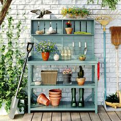 an outdoor garden with potted plants and gardening tools on the shelves, including watering utensils