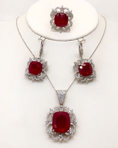 "Gorgeous and stunning set of ring, earrings, pendant and linked chain 18k solid white gold,diamond and cushion cut rubies. Total weight : 43.4 grams Total ruby weight appx : 51.31 TCW, lab created. Total diamond weight: 4.05 TCW Diamond clarity: VS1-2 (loupe clean) Diamond color: F (colorless) Pendant size appx : 40*25 mm, with the bail Earrings size appx : 40×20 mm ( longest to widest point ) Type of earrings fastening : Lever back Ring width on the top: 25 mm Chain length: 18\" Chain thicknes Luxury Ruby Jewelry With Polished Finish, Luxury Polished Ruby Jewelry, Fine Jewelry Sets In White Gold With Gemstones, Luxury Ruby Pendant Jewelry, Elegant Ruby Jewelry With Polished Finish, Diamond Jewelry With Polished Finish And Cushion Cut, Cushion Cut Diamond Jewelry With Polished Finish, Fine Jewelry With Lab-created Ruby Gemstone, Luxury Jewelry With Prong Setting And Lab-created Ruby