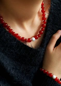 Embark on a journey of auspiciousness with our stunning Natural Red Agate Necklace and Bracelet set – where good fortune meets timeless beauty! 🔴✨Let the red waves of luck and prosperity adorn you in the upcoming New Year! 🧧 Key Features: Material: Authentic red agate beads paired with a lustrous natural pearl for a touch of elegance. Symbolism: Embrace the vibrant energy of the New Year with the auspicious hues of red, symbolizing luck and prosperity. Unique Touch: Each set features natural agate beads, with variations in shades ranging from translucent tomato red to rich cherry red, making each piece truly one-of-a-kind. Versatile Style: Perfect for ushering in the Lunar New Year with warmth and style, enhancing your overall charm. Captivating Hues: Feel the passion of translucent toma Elegant Good Luck Bracelets With Natural Stones, Elegant Red Agate Beaded Bracelets, Elegant Red Carnelian Beaded Bracelets, Red Agate Beaded Necklaces With Round Beads, Red 8mm Beads Jewelry For Meditation, Red Agate Beaded Necklace With Gemstone Beads, Spiritual Red Necklace With Natural Stones, Elegant Red Agate Necklace, Red Carnelian Spiritual Jewelry