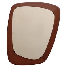 a mirror that is sitting on top of a wooden frame and has a white background