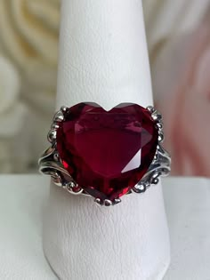 Red Heart Gem Sterling Silver RingHeart Leaf Design#D213 This Gothic inspired lovely filigree ring is set with a 10ct flawless red gemstone. This heart gemstone is 15mm x 15mm. The rings sits 11mm off the finger. Notice the beautiful gothic design of the silver filigree setting and band. The inside of the band is marked 925 for sterling silver. This is an exquisite rendition of an antique filigree ring. The sterling filigree cradles the stone in a delicate caress. Classic and beautiful, this vin Garnet Heart Ring, Vampire Rings, Vampire Ring, Gothic Wedding Rings, Heart Gem, Garnet Heart, Gothic Ring, Gem Art, Antique Jewelry Rings