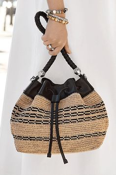 This fresh and flirty natural raffia straw bag is hand-crocheted with a detailed chain-link motif woven into the body. Deceptively roomy, it goes with everything. The multi-strand Italian handcrafted pebbled leather strap and black leather crossbody strap give it great versatility. Multi Strand, Crossbody Strap, Hand Crochet, Pebbled Leather, Leather Crossbody, Chain Link, All Black, Straw Bag, Leather Straps