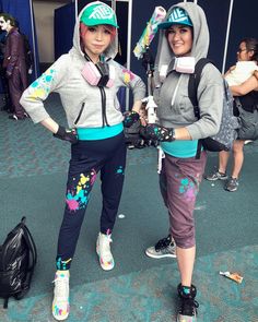 two women standing next to each other wearing roller skates