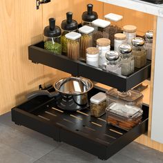 an open drawer in a kitchen filled with spices and other cooking utensil items