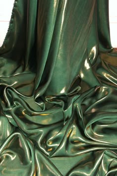 the green fabric is very shiny and smooth