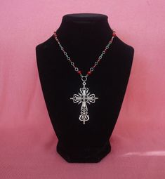 Large gothic cross pendant with a rosary-style chain featuring red Czech beads and others. Perfect for simple gothic styles or to layer with other pieces. Gothic Beaded Cross Jewelry, Red Cross Pendant Necklace Gift, Red Cross Pendant Necklace For Gift, Red Gothic Cross Necklace, Red Crucifix Cross Necklace Gift, Red Crucifix Cross Necklace For Gift, Gothic Cross Necklaces For Jewelry Making, Handmade Red Cross Pendant Jewelry, Handmade Red Cross Jewelry