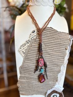 Wear this fun necklace long or as a lariat. The necklace is a matt orange crystal this is hand knotted and is accented with brown leather. The pendant is pink marbled agate, genuine turquoise , and crystal. Wear with an white t-shirt for a fun accessory Necklace measures approximately 33" with a 5" pendant. Bohemian Pink Lariat Jewelry, Pink Bohemian Lariat Jewelry, Bohemian Brown Lariat Beaded Necklaces, Adjustable Brown Lariat Necklaces, Adjustable Bohemian Lariat Necklace With Gemstone Beads, Bohemian Adjustable Lariat Necklace With Gemstone Beads, Adjustable Beaded Brown Lariat Necklace, Adjustable Brown Beaded Lariat Necklace, Bohemian Gemstone Beads Lariat Necklace