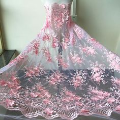 a dress with pink flowers is on display