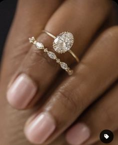 a woman's hand with a ring on it and a diamond in the middle