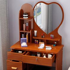 a wooden vanity with drawers and a mirror