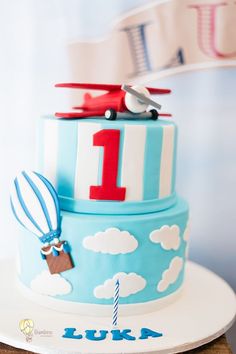 a birthday cake with an airplane and hot air balloon on top