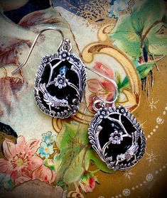 Inspired by the caged velvet perfume buttons from the Civil War era, a silver-plated overlay on faux black jet is the descendant of coveted mourning jewelry borrowed from the jewel box of someone’s great, great grandmother. These feather-light earrings with surgical steel French wires will complement gray and black attire. Both dressy and casual. 1” Gothic Sterling Silver Filigree Jewelry, Nickel-free Vintage Jewelry For Evening, Nickel Free Vintage Jewelry For Evening, Vintage Nickel-free Jewelry For Evening, Gothic Antique Silver Jewelry For Formal Occasions, Victorian Jewelry With Oxidized Metal Finish, Victorian Oxidized Metal Jewelry, Antique Silver Gothic Jewelry For Formal Occasions, Ornate Antique Silver Nickel-free Jewelry