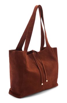 Plush suede and a slouchy silhouette bring a boho-chic appeal to this tote finished with a touch of polished hardware that adds gleaming contrast. Top carry handles Top tie closure Lined Leather Imported Chic Suede Tote Shoulder Bag, Large Capacity Brown Suede Bag, Rectangular Suede Hobo Shopping Bag, Suede-lined Hobo Shoulder Bag For Shopping, Suede Tote Bag With Gold-tone Hardware, Burnt Orange, Beach Bag, Boho Chic, Nordstrom