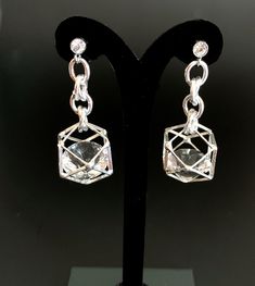 Unusual, sparkly diamond shaped crystals are captured in silver plated cages. I have joined them to the crystal, non allergenic, stainless steel posts with chain maille. Nice neutral earrings will go with anything. Makes a lovely gift. Here is a link to my whole shop: https://www.etsy.com/shop/designsbymalone RETURNS - BUY WITH CONFIDENCE Don't worry, I will refund or exchange an item up to 60 days. Makes gift giving easy! All my items will arrive in a gift box and/or a velvet or organza pouch. Crystal Evening Earrings, Metal Drop Crystal Earrings For Anniversary, Silver Crystal Earrings With Diamond Accents As Gift, Silver Crystal Earrings With Diamond Accents For Evening, Party Earrings With Clear Metal, Silver Crystal Earrings With Sparkling Stones For Gift, Silver Metal Crystal Earrings For Anniversary, Modern Silver Crystal Earrings, Modern Silver Metal Crystal Earrings