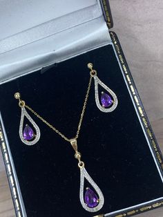 Elegance is redefined by this parure Amethyst set, crafted in luxurious yellow gold. The intense purple amethyst is surrounded by a halo of glistening brilliant white diamonds. A modern take on a vintage design further elevate the allure of this beautiful set 💜 Formal Yellow Gold Gemstone Jewelry Sets, Formal Yellow Gold Jewelry Sets With Gemstones, Luxury Purple Teardrop Jewelry, Gold Amethyst Jewelry With Diamond Accents, Purple Cubic Zirconia Jewelry Sets For Gift, Purple Cubic Zirconia Jewelry Sets As Gift, Luxury Purple Drop Jewelry, Elegant Purple Jewelry Sets For Formal Occasions, Gold Amethyst Jewelry For Anniversary