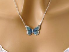 This silver butterfly necklace features a dainty teal butterfly, a beautifully detailed antiqued silver plated pewter butterfly pendant with sparkly blue and green enamel, hanging from a sterling silver or silver plated chain that secures with a lobster clasp. Easily dresses up or down. Length: choose 16 to 30 inches (shown at 18 inches) Pendant: 1 x 1 3/8 inches Arrives with a Marty White card in a lovely decorative bag, all wrapped in tissue paper and bubble wrap packaging. **Mark my shop as a Handmade Butterfly-shaped Metal Jewelry, Handmade Butterfly Shaped Metal Jewelry, Elegant Blue Sterling Silver Butterfly Necklace, Turquoise Butterfly Sterling Silver Jewelry, Butterfly-shaped Metal Necklace As A Gift, Metal Butterfly Necklace As Gift, Metal Butterfly Necklace Gift, Butterfly Shaped Metal Necklace As Gift, Butterfly Shaped Metal Necklace Gift