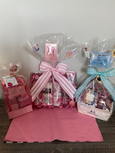 a pink table topped with lots of candy and wrapped in cellophane wrappers