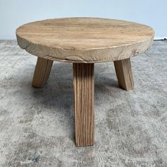 a wooden table sitting on top of a carpeted floor