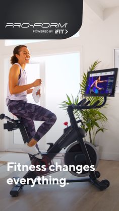 a woman is riding an exercise bike with the words fitness changes everything in front of her