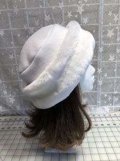 "I made this beautiful Snow White hat out of soft white beaver faux fur and white fleece. The brim is a 3 1/2 inch frame of white beaver faux fur and the hat is lined with a double layer of white fleece for warmth and comfort. Sized to fit most adults 22\"-23\" around head. The hat is a comfortable fit on my 22 1/2\" head. Spot clean or dry clean. Handmade in Albany, Oregon by me!" White Hat With Faux Fur Lining For Winter, White Winter Hat With Faux Fur Lining, White Fur Felt Hat For Winter, White Fur Felt Winter Hat, White Beanie Costume Hat For Winter, White Winter Beanie Costume Hat, White Curved Brim Fur Felt Hat, White Beanie For Winter Costume, White Short Brim Felt Hat For Winter