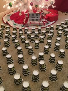 a christmas tree is surrounded by stacks of cups