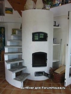 a white fireplace sitting inside of a living room next to a set of staircases