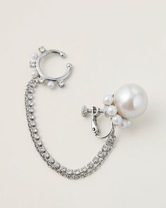 This modern and playful 4-way chained earring is inspired by this season's gothic rock theme. Cast from silver plated brass with delicate faux pearls and luminous crystals. The ear cuff is linked to the bottom pearl earring with chains, it can be detached and worn as a nose ring for elevating a glam punk look. You can also wear the pearl earring as a single piece with dangling chains. Glam Punk, Punk Looks, Gothic Glam, Gothic Rock, White Brass, Pearl Earring, The Pearl, Chain Earrings, Brass Color