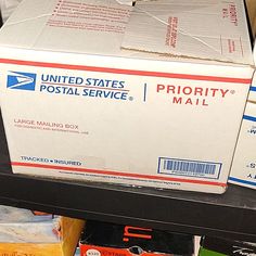 a postal mail box sitting on top of a shelf next to other boxes in a store