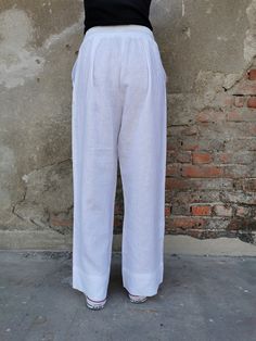 "White Linen Pants, Wide Leg Linen Pants, ✥ Welcome to my world! I create my design in my dreams and I draw geometric lines and extravagant patterns with scissors, needles and thread. Be my dream catcher and let me create for you a parallel fashion world! ✥ SHIPPING Express shipping: 2-3 biz days via DHL Worldwide ✥ SIZING The model in the picture wears size M. Height: 5'9\" and weigh 60 kg. Available sizes: XS - 3XL Please, refer to my Size Chart below to find your perfect size match! Keep in m Daywear Straight Pants With Pockets, White Linen Full-length Bottoms, Straight Pants With Pockets For Daywear, Casual Solid Color Daywear Pants, Straight Leg Pants With Pockets For Daywear, White Harem Pants With Pockets And Loose Fit, Tapered Leg Bottoms With Pockets For Daywear, Relaxed Fit Solid Bottoms For Daywear, Loosely Fitted Tapered Leg Bottoms For Daywear