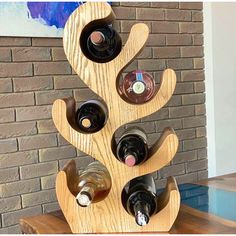 a wine rack made out of wood with several bottles in it and one on top of the other