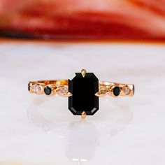 a black diamond ring sitting on top of a table