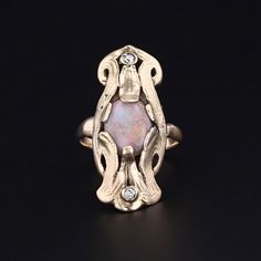 Opal is the beloved birthstone of October, known for its ability to delight all those who gaze upon it with its rainbow flashes of color that can shift and change in an instant. This antique 10k gold ring (circa 1910-1920) features a vibrant opal with flashes of orange and green and two diamond accents. The face of the ring measures 1.1 inches from top to bottom by 0.5 inches wide. The ring is in very good condition; however, the opal is a later replacement stone. It is currently a size 5.5 but Collectible Gold Opal Ring With Gemstone, Collectible Gold Opal Gemstone Ring, Oval 14k Gold Art Nouveau Ring, 14k Gold Art Deco Birthstone Jewelry, Art Deco 14k Gold Birthstone Jewelry, Antique Opal Rings For Collectors, Antique Opal Rings Collectible, Antique Opal Rings For Collectible, Heirloom Yellow Gold Opal Ring With Accent Stones