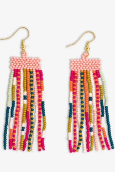 the multicolored beaded fringe earrings are hanging from gold - plated hooks