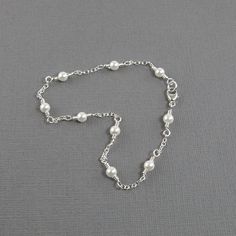 Lovely pearl anklet made with white freshwater pearls and sterling silver chain. A classy and sophisticated ankle bracelet that will not only make your legs look great, but will make a wonderful addition to your jewelry collection. Please choose the size that you need from the drop down menu, bearing in mind that the anklet should be approximately one inch larger than the size of your ankle. The anklet will arrive in an attractive gift box. Elegant Pearl Anklets For Wedding, Elegant Silver Pearl Bracelet With Extender, Elegant Pearl Drop Anklets As Gift, Elegant Silver Anklets For Formal Occasions, Elegant Pearl Anklets As Gift, Elegant Wedding Anklets With Adjustable Chain, Elegant Wedding Anklets With Pearl Chain, Elegant Anklets With Extender, Elegant Pearl Chain Anklets For Wedding