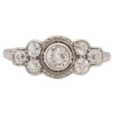 an antique diamond ring with five stones in the center