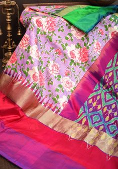 This  printed Pochampalli saree offers a stunning juxtaposition of vivid florals on Lilac, with a wide border of traditional ikkat weaving on the pallu. The body of the saree is Lilac, providing a classic backdrop to the intricate patterning and luxurious grandeur. SILK MARK CERTIFIED This saree is ready to wear with fall and pico done. Handmade silk tassels adorn the pallu and add more grace to it. An unstitched blouse fabric is included. *Note: There may be minor variations in the shade, the t Luxury Traditional Fabric With Pallu, Luxury Unstitched Silk Mark Certified Traditional Wear, Multicolor Paithani Silk Pre-draped Saree For Navratri, Designer Multicolor Pre-draped Saree With Printed Motifs, Festive Multicolor Pre-draped Saree With Floral Print, Multicolor Ikat Print Pre-draped Saree For Navratri, Navratri Ikat Print Pre-draped Saree, Multicolor Silk Lehenga With Digital Print, Traditional Multicolor Pre-draped Saree With Floral Print