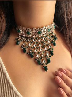 Adorn yourself in timeless elegance with this exquisite green Kundan and zircon necklace set, perfect for weddings and special occasions. Crafted with meticulous attention to detail, the set features delicate green hues reminiscent of Pakistani and Punjabi traditions, with a touch of Bollywood glamour. Complete with matching earrings and a stunning maangtika, this Indian Kundan ensemble effortlessly captures the essence of sophistication and grace. Measurements:   Necklace Length-14" Necklace Wi Elegant Green Meenakari Bridal Necklace, Green Kundan Bridal Necklace Hand Set, Green Bridal Sets For Diwali Reception, Diwali Reception Green Bridal Sets, Green Kundan Necklace For Reception, Green Bollywood Kundan Necklace With Zari Work, Green Chandbali Bridal Necklace For Reception, Green Tilla Bridal Necklace For Reception, Green Bollywood Bridal Sets For Reception